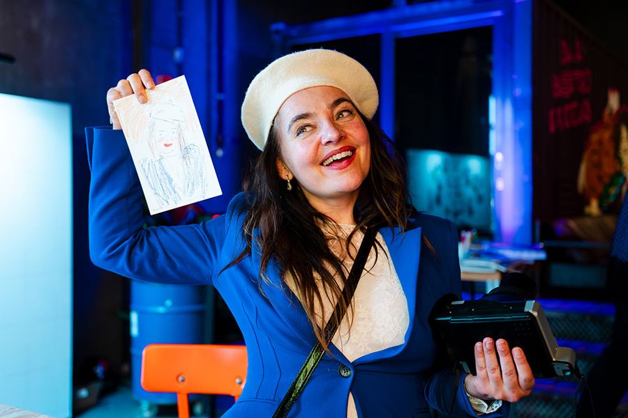 Guest showing a drawn portrait at the live portrait station