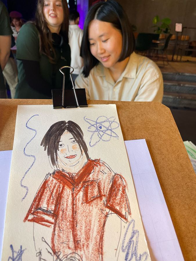 Guest sitting while a live portrait is being drawn